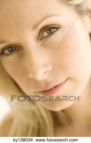 Portrait of a young woman looking at camera View Large Photo Image Picture - Portrait of a young woman looking at camera. Fotosearch