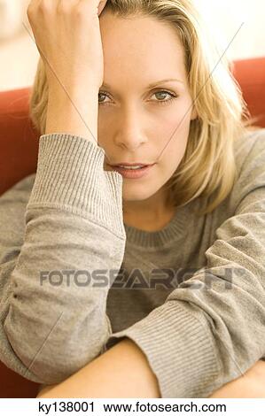 Portrait of a young woman looking at camera View Large Photo Image Stock Image - Portrait of a young woman looking at camera. Fotosearch