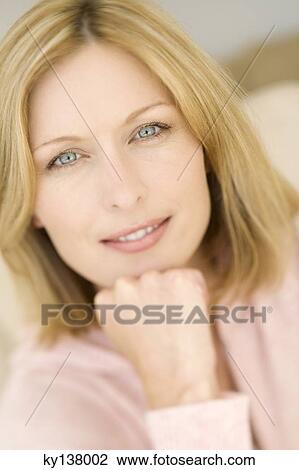 Portrait of a young woman looking at camera View Large Photo Image Stock Image - Portrait of a young woman looking at camera. Fotosearch