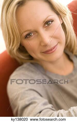 Portrait of a young woman looking at camera View Large Photo Image Stock Image - Portrait of a young woman looking at camera. Fotosearch