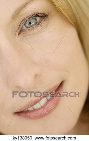 Stock Image - Portrait of a young woman looking at camera. Fotosearch