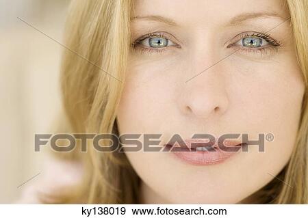 Stock Photo - Portrait of a young woman looking at camera. Fotosearch
