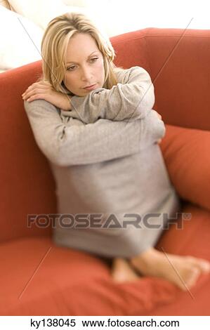 Young thinking woman sitting on a sofa View Large Photo Image Stock Photography - Young thinking woman sitting on a sofa. Fotosearch