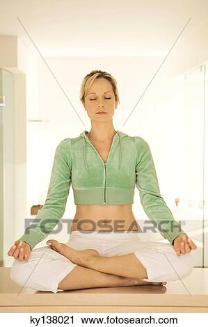 Young woman in yoga position View Large Photo Image Stock Image - Young woman in yoga position. Fotosearch