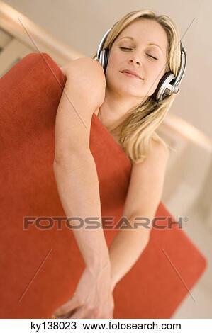 Young woman listening to music with headphones View Large Photo Image Stock Image - Young woman listening to music with headphones. Fotosearch