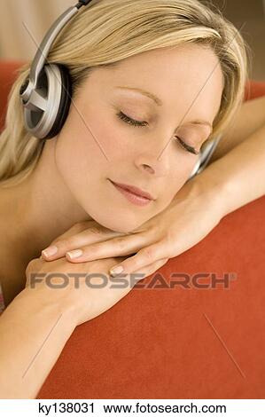 Young woman listening to music with headphones View Large Photo Image Stock Image - Young woman listening to music with headphones. Fotosearch