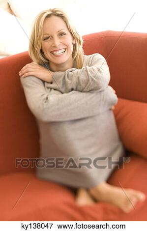 Young woman smiling for the camera View Large Photo Image Stock Photo - Young woman smiling for the camera. Fotosearch