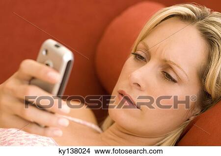 Young woman using mobile phone View Large Photo Image Picture - Young woman using mobile phone. Fotosearch