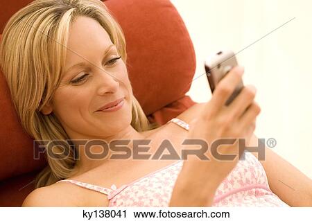 Young woman using mobile phone View Large Photo Image Stock Image - Young woman using mobile phone. Fotosearch