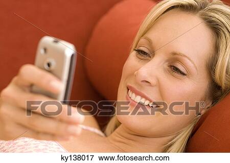 Young woman using mobile phone View Large Photo Image Stock Photo - Young woman using mobile phone. Fotosearch
