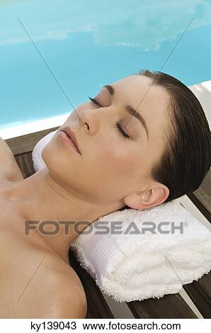 Portrait of a young woman sleeping near a pool, outdoors View Large Photo Image Stock Image - Portrait of a young woman sleeping near a pool, outdoors. Fotosearch