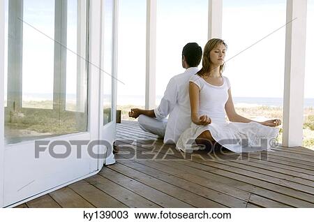 Young couple in yoga attitude, outdoors View Large Photo Image Stock Image - Young couple in yoga attitude, outdoors. Fotosearch