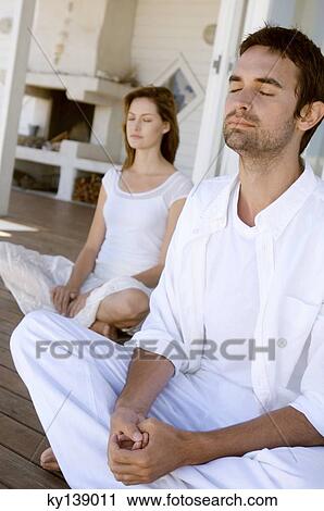 Young couple in yoga attitude, outdoors View Large Photo Image Stock Image - Young couple in yoga attitude, outdoors. Fotosearch