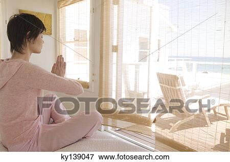 Young woman in yoga attitude, indoors View Large Photo Image Stock Photo - Young woman in yoga attitude, indoors. Fotosearch