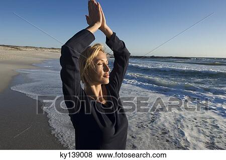 Young woman in yoga attitude on the beach, outdoors View Large Photo Image Stock Photo - Young woman in yoga attitude on the beach, outdoors. Fotosearch