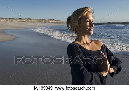 Young woman in yoga attitude on the beach, outdoors View Large Photo Image Stock Photo - Young woman in yoga attitude on the beach, outdoors. Fotosearch