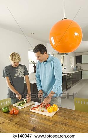 Man and teen boy preparing meal in kitchen View Large Photo Image Stock Photo - Man and teen boy preparing meal in kitchen. Fotosearch