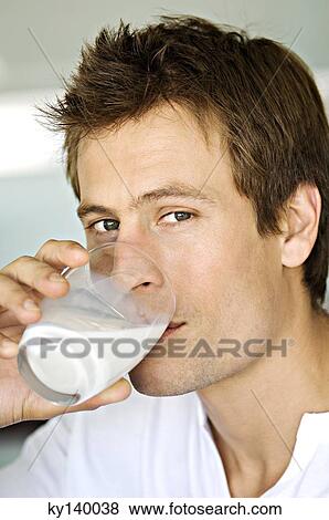 Portrait of a man drinking glass of milk View Large Photo Image Stock Photo - Portrait of a man drinking glass of milk. Fotosearch