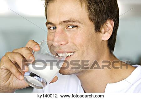 Portrait of a young man drnking glass of milk View Large Photo Image Stock Image - Portrait of a young man drnking glass of milk. Fotosearch
