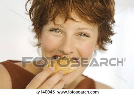Portrait of a young woman eating bread View Large Photo Image Stock Photography - Portrait of a young woman eating bread. Fotosearch