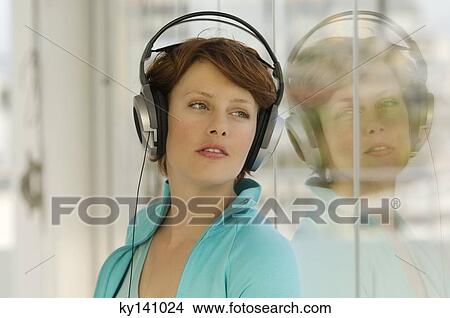 Portrait of a young woman, listening to music with headphones View Large Photo Image Picture - Portrait of a young woman, listening to music with headphones. Fotosearch