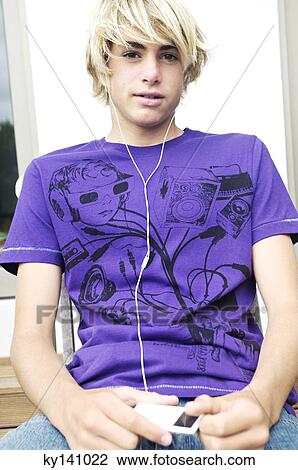 Stock Image - Teen boy listening to MP3 player. Fotosearch