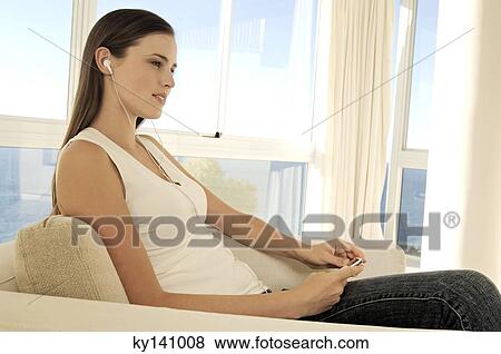 Young woman listening to MP3 player View Large Photo Image Stock Photo - Young woman listening to MP3 player. Fotosearch