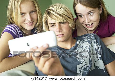 3 teenagers using camera phone View Large Photo Image Stock Photo - 3 teenagers using camera phone. Fotosearch