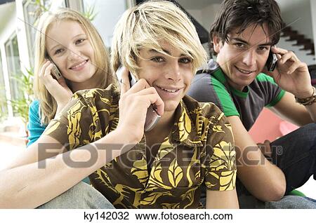 3 teenagers using mobile phones View Large Photo Image Stock Image - 3 teenagers using mobile phones. Fotosearch
