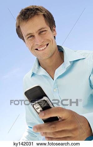 Portrait of a man using camera phone View Large Photo Image Stock Image - Portrait of a man using camera phone. Fotosearch
