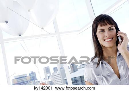 Portrait of a smiling woman phoning, holding white balloons View Large Photo Image Stock Image - Portrait of a smiling woman phoning, holding white balloons. Fotosearch