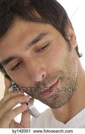 Portrait of a young man using mobile phone View Large Photo Image Stock Image - Portrait of a young man using mobile phone. Fotosearch