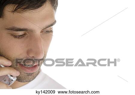 Stock Photo - Portrait of a young man using mobile phone. Fotosearch