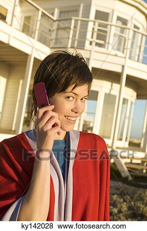Portrait of a young woman using mobile phone, outdoors View Large Photo Image Stock Photo - Portrait of a young woman using mobile phone, outdoors. Fotosearch