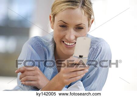 Young woman using mobile phone View Large Photo Image Stock Photography - Young woman using mobile phone. Fotosearch