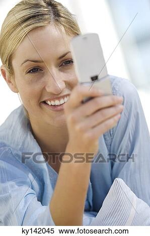 Young woman using mobile phone View Large Photo Image Stock Photography - Young woman using mobile phone. Fotosearch