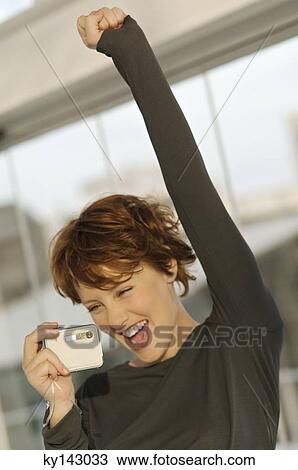 Portrait of a young woman using digital camera View Large Photo Image Stock Image - Portrait of a young woman using digital camera. Fotosearch