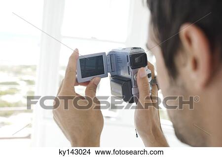 Young man using camcorder View Large Photo Image Picture - Young man using camcorder. Fotosearch