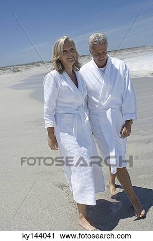 Couple in bathrobe walking on the beach View Large Photo Image Stock Image - Couple in bathrobe walking on the beach. Fotosearch