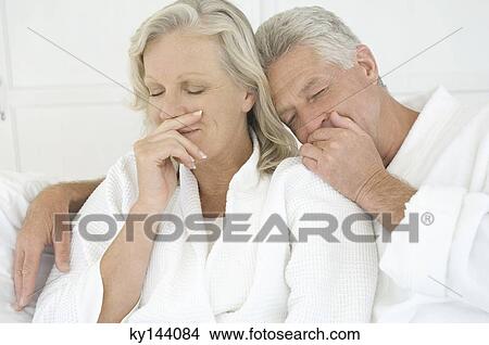 Picture - Couple in bathrobe with eyes closed. Fotosearch