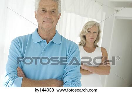 Couple with arms crossed, looking at camera View Large Photo Image Stock Photo - Couple with arms crossed, looking at camera. Fotosearch