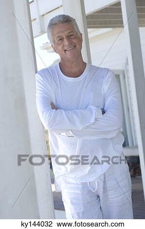 Man with arms crossed, smiling for the camera View Large Photo Image Stock Image - Man with arms crossed, smiling for the camera. Fotosearch