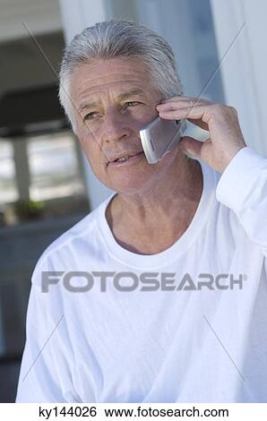 Stock Photograph - Portrait of man using mobile phone. Fotosearch