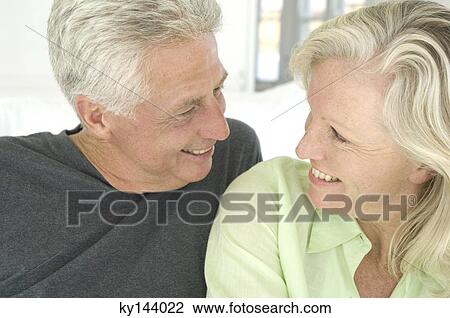 Portrait of smiling couple looking at each other View Large Photo Image Stock Image - Portrait of smiling couple looking at each other. Fotosearch