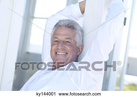 Portrait of smiling man with arms raised View Large Photo Image Stock Image - Portrait of smiling man with arms raised. Fotosearch