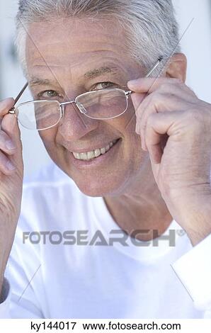 Portrait of smiling man with eyeglasses View Large Photo Image Stock Photo - Portrait of smiling man with eyeglasses. Fotosearch