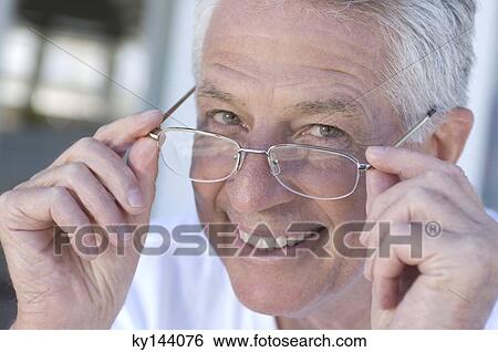 Portrait of smiling man with eyeglasses View Large Photo Image Stock Photograph - Portrait of smiling man with eyeglasses. Fotosearch