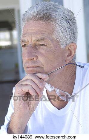 Portrait of thinking man holding eyeglasses View Large Photo Image Stock Photo - Portrait of thinking man holding eyeglasses. Fotosearch