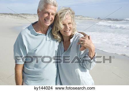 Smiling couple embracing on the beach View Large Photo Image Picture - Smiling couple embracing on the beach. Fotosearch