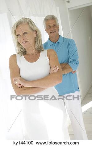 Smiling couple with arms crossed View Large Photo Image Stock Image - Smiling couple with arms crossed. Fotosearch